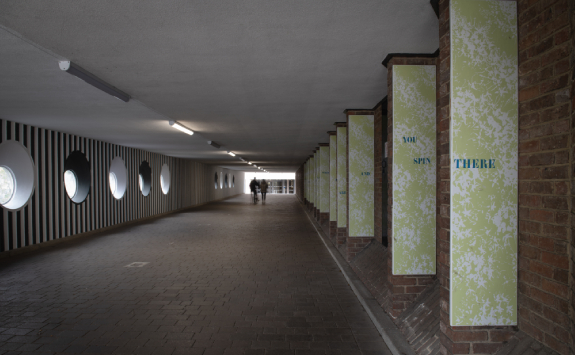 Detail of Welcome to the Palindrome by Bridget Jones and Lisa France. 26 panels line a pedestrian tunnel, with a single word from a poem printed on each panel.